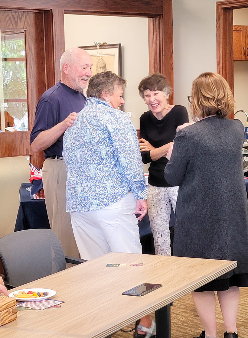 Group of people talking at even in library community room